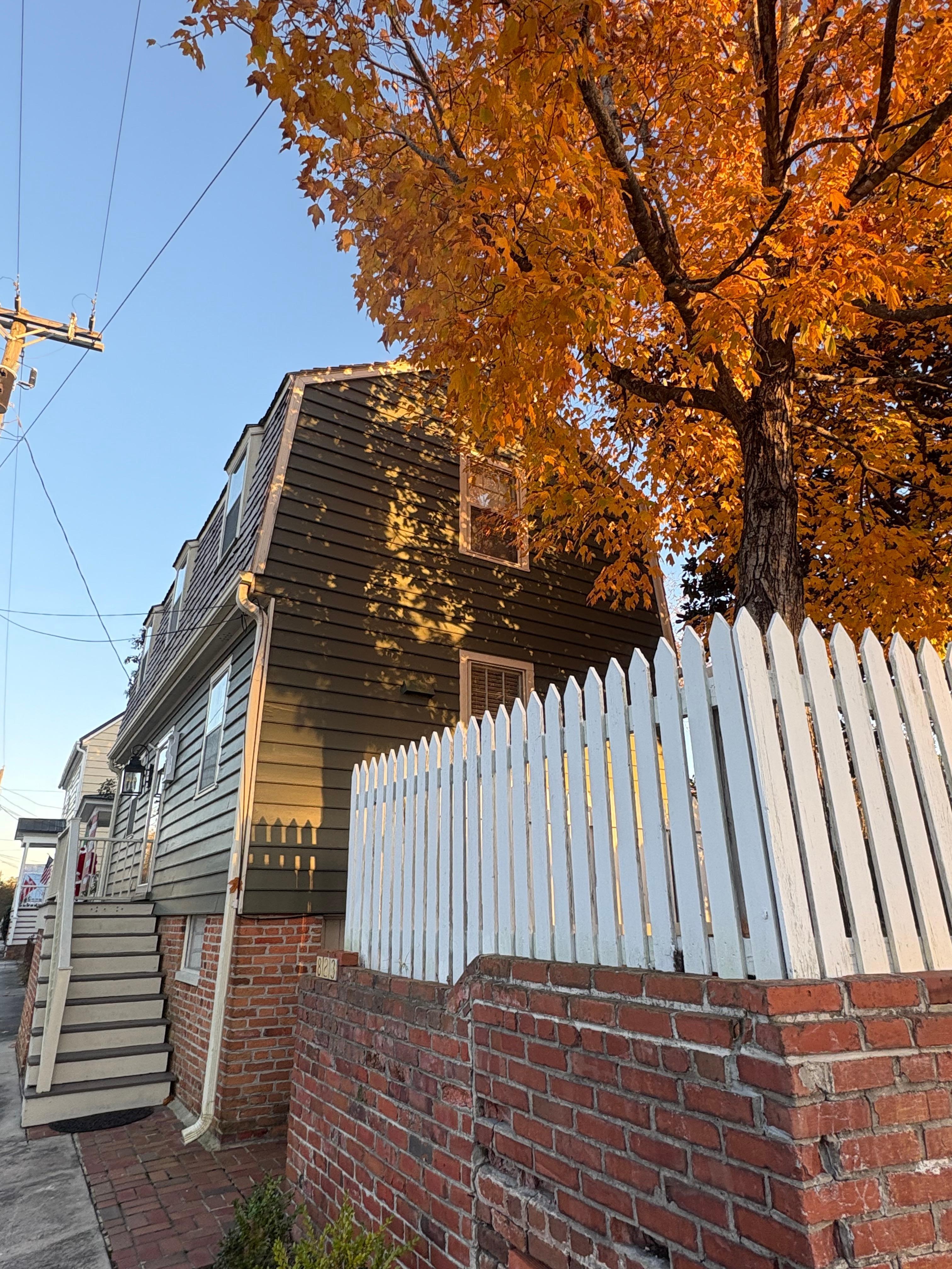 Beautiful corner lot with brick wall and picket fence for privacy. Gated driveway for off street parking.