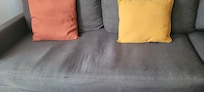 Worn-out sofa; the owner claimed it was new