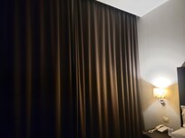 Love the ceiling to floor curtains cover windows with view of port terminal and ships