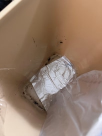 Inside the trashcan. As you can see, staff kept putting the bag on the side but not cleaning the can.