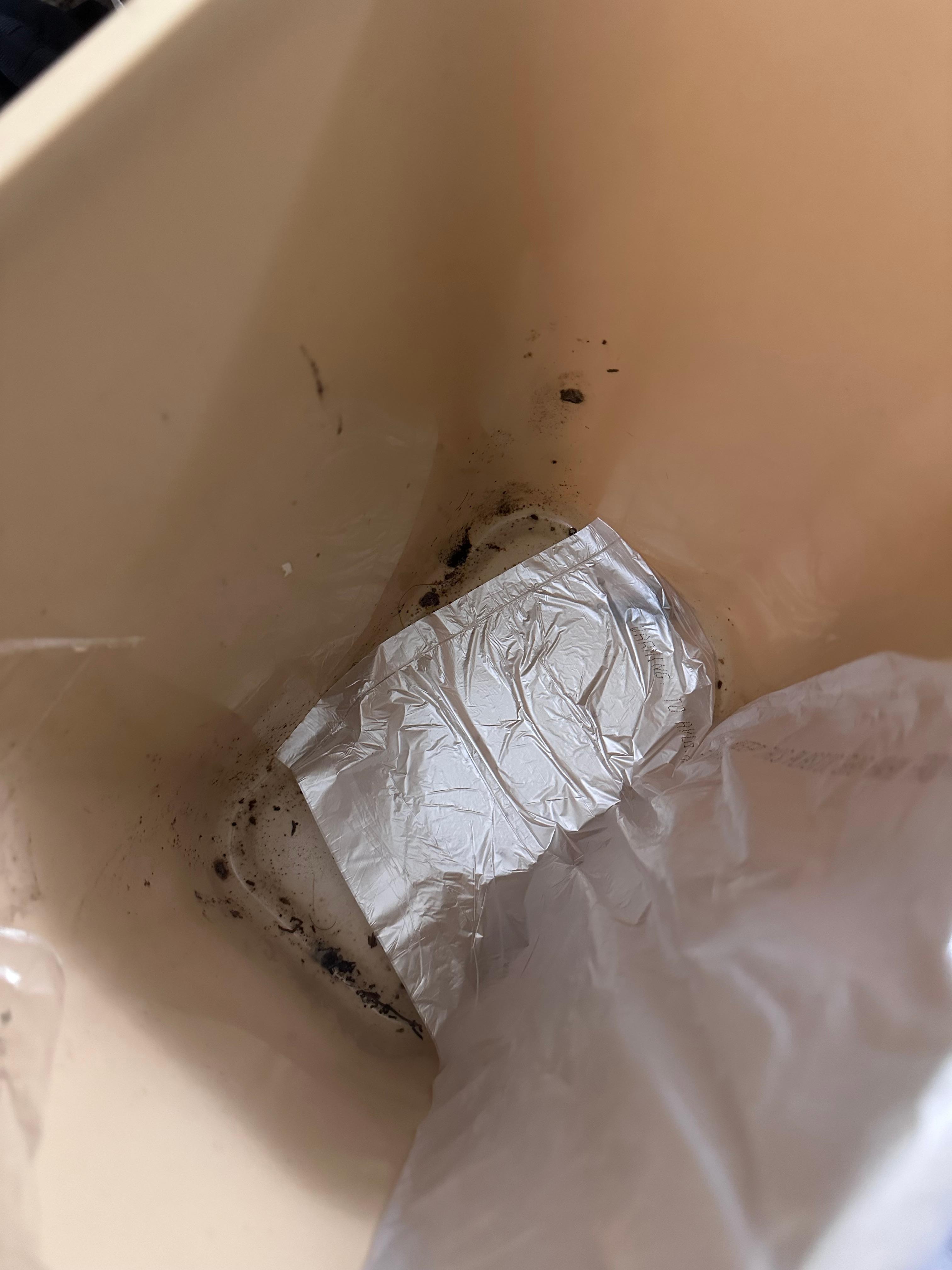 Inside the trashcan. As you can see, staff kept putting the bag on the side but not cleaning the can.