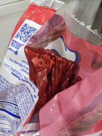 Candy nibbled by mice in a grocery bag overnight in the bedroom.