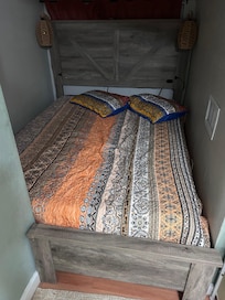 Queen bed surrounded by three walls. Worse then access to a sailboats V birth