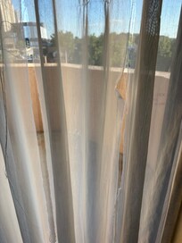 The torn sheer curtain we saw when we checked in!