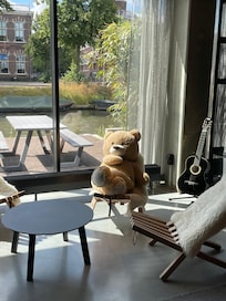 A friendly teddy bear in the lobby