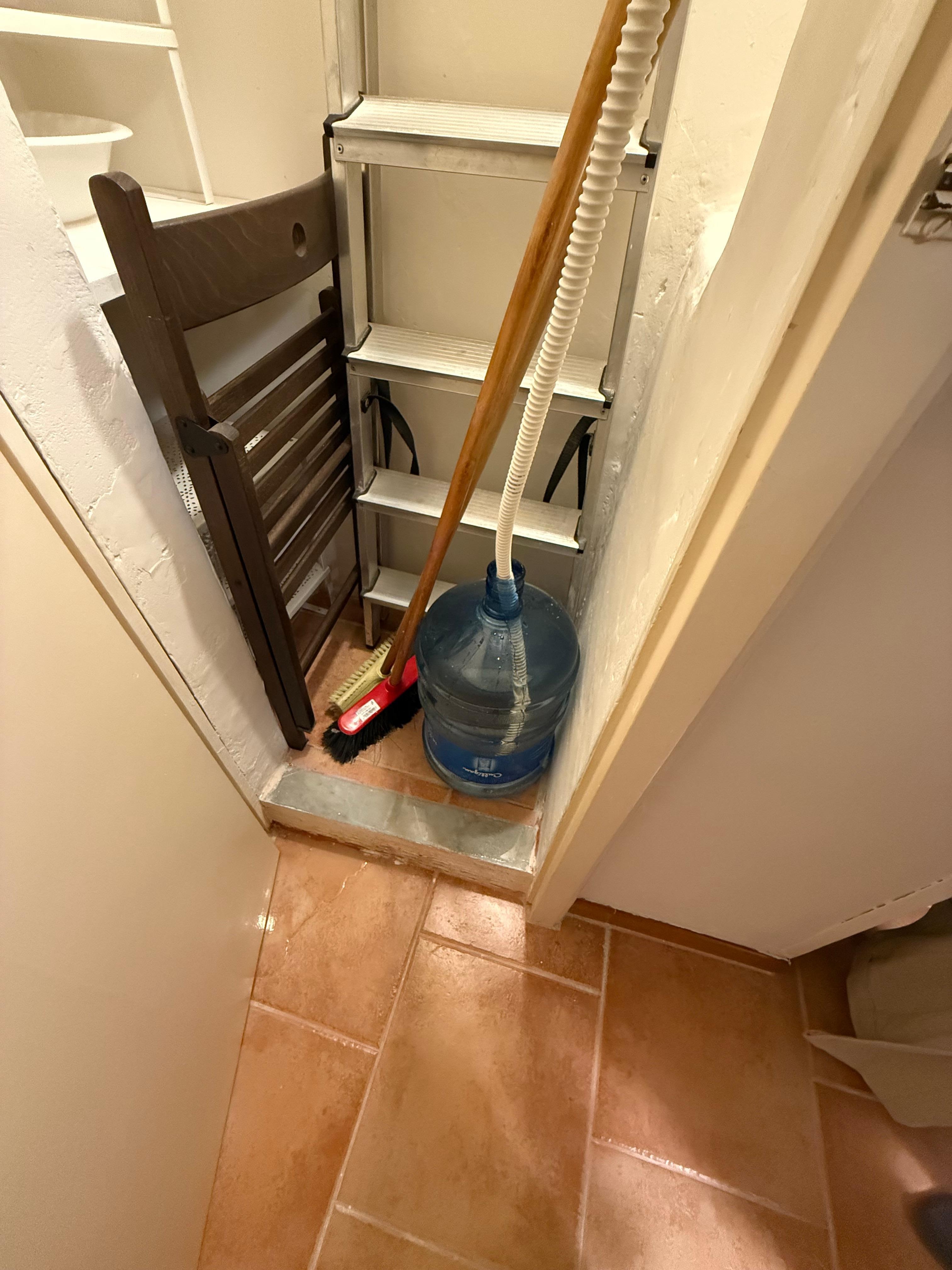 Closet with jug being filled by A/C water