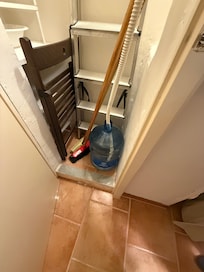 Closet with jug being filled by A/C water