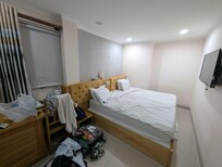 Tiny room, beds pushed together and not in alignment with headboards