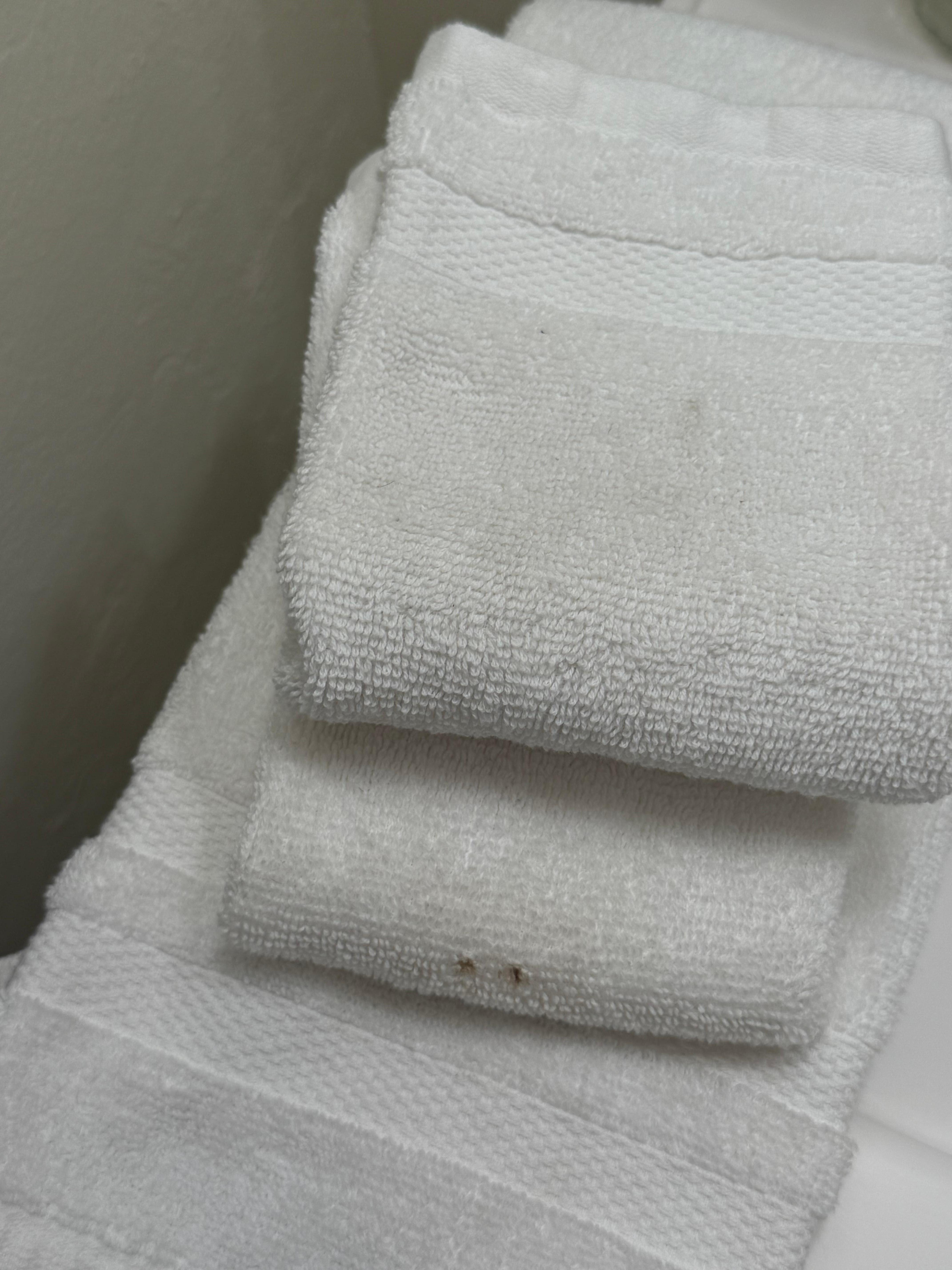 Stained towel with embedded pubic hairs