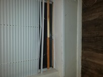 Window which won't lock, had to put hangers there to secure