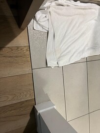 Flooring at shower stall gets wet outside shower due to half glass divider and wrong big shower head at bedroom area.