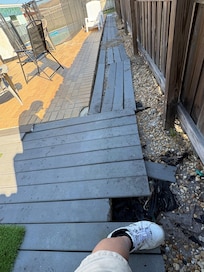 Rotting broken and hazardous decking. Exposed metal anchors that slice open any bare foot.