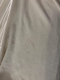 dirty blanket on bed.