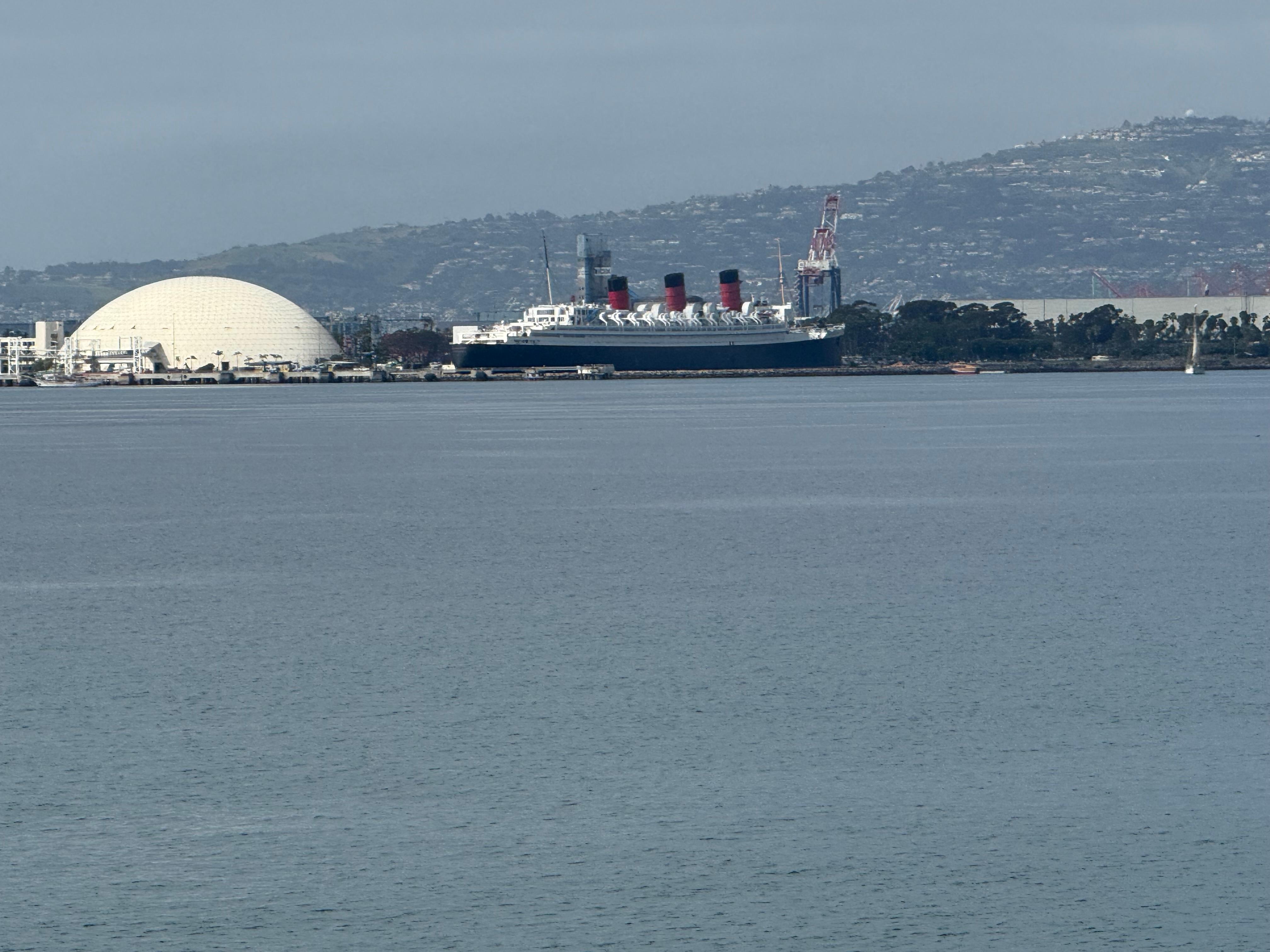 Queen Mary visible from the beach walkway 