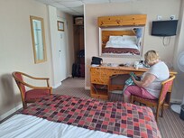 Spacious bedrooms with storage, large dressing mirror but small TV.