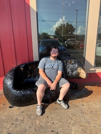 BOYFRIEND ON A BEAR BENCH WHILE SHOPPING