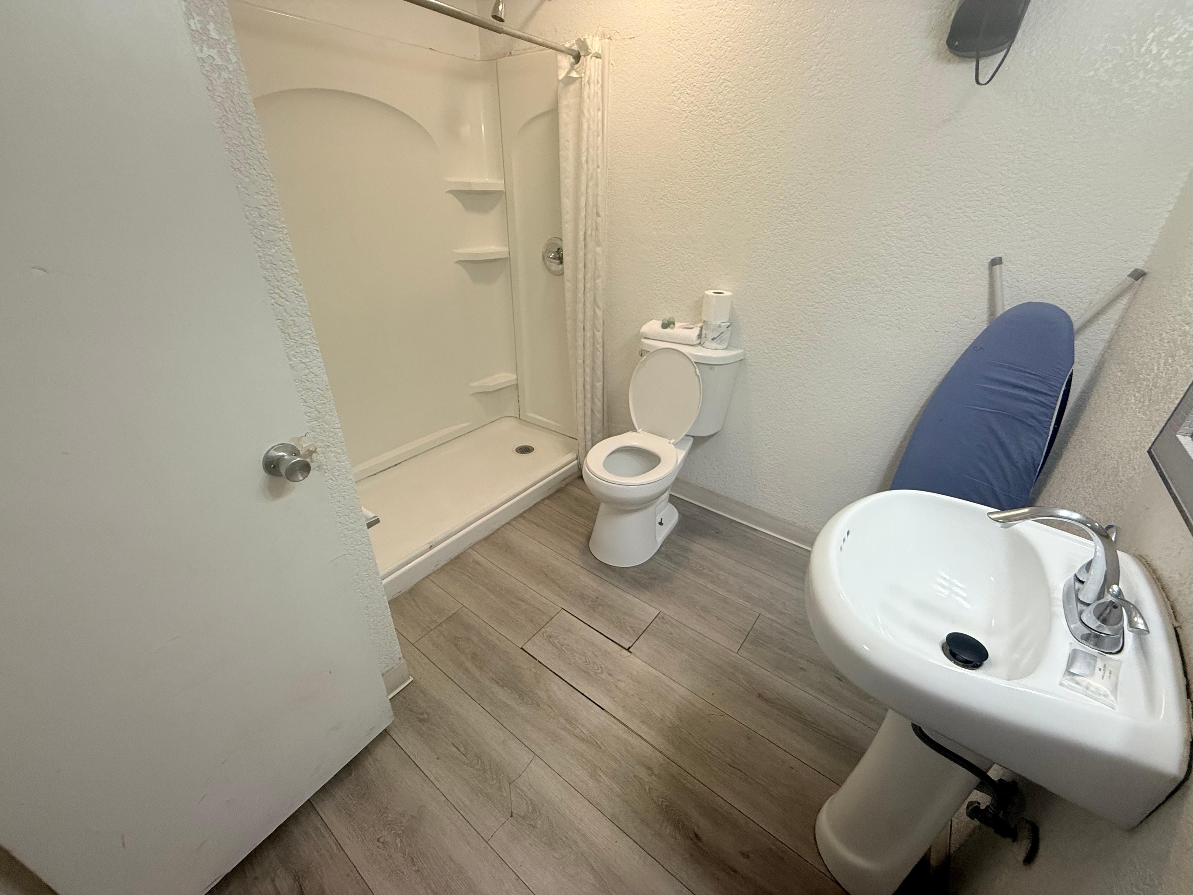 Basic bathroom accommodations with no surface near sink. Shower pressure good)