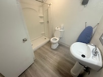 Basic bathroom accommodations with no surface near sink. Shower pressure good)