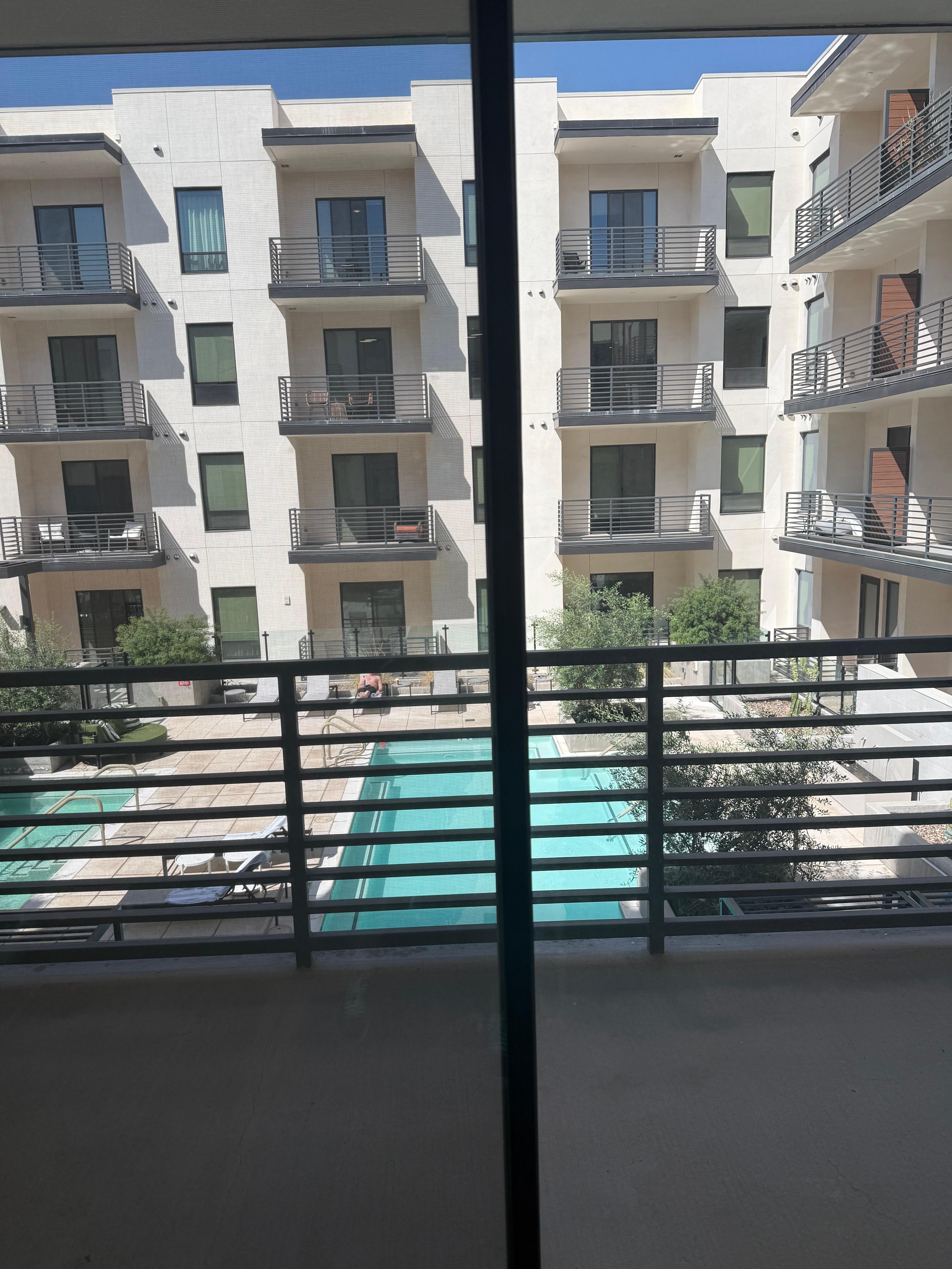 The view from the living room. Facing a courtyard. Very visible to others.   Not very private.  There are no sheers but blinds are available.  When you put the blinds down it’s very dark inside.  