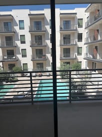 The view from the living room. Facing a courtyard. Very visible to others. Not very private. There are no sheers but blinds are available. When you put the blinds down it’s very dark inside.