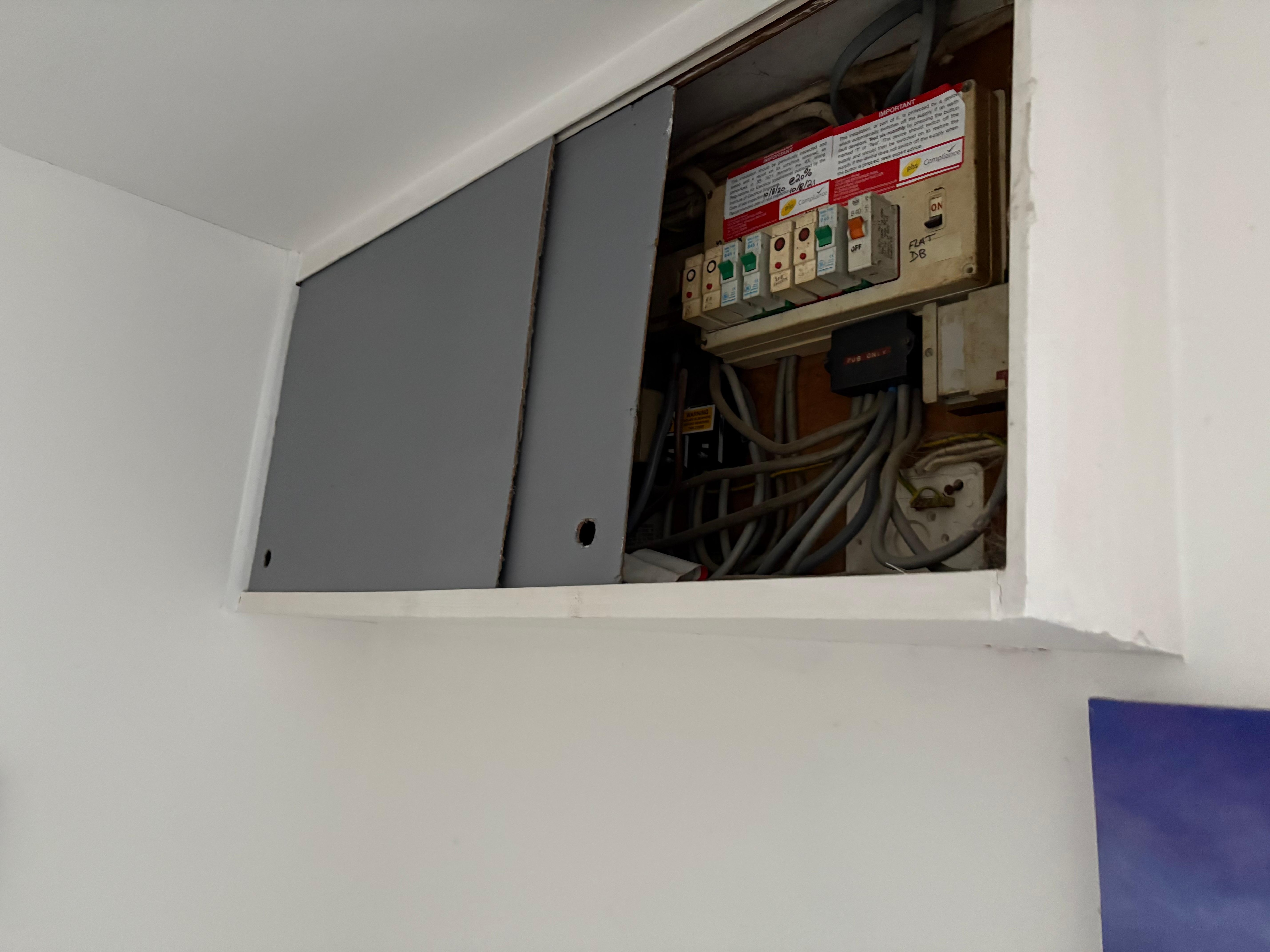Electricity cupboard above our bed