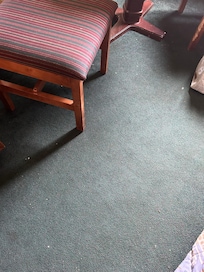 Debris on floor and worn furniture