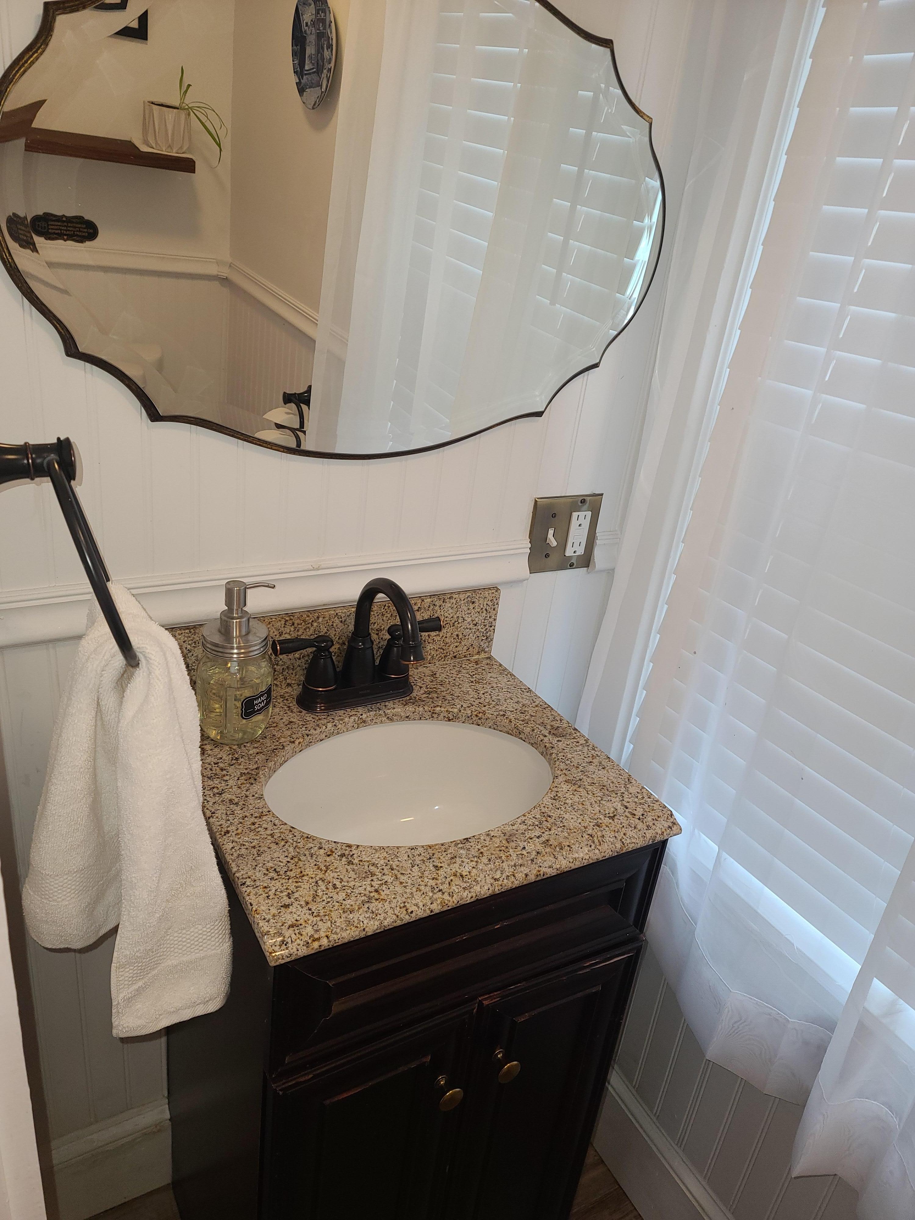The 1/2 bath is off the kitchen. Clean and adorable. 