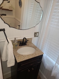 The 1/2 bath is off the kitchen. Clean and adorable.