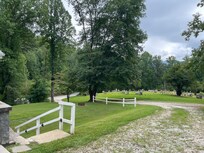 Looking out the driveway to the cemetery across the drive.