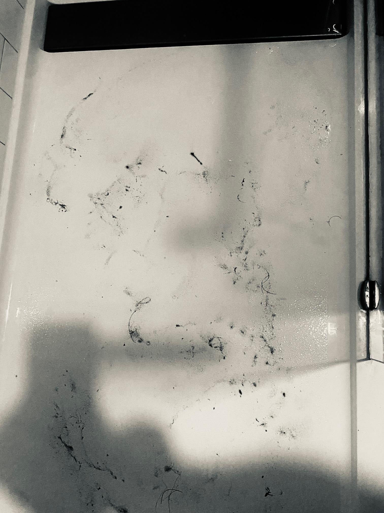 Footprints in the shower from the dirt from waling on the room floor.