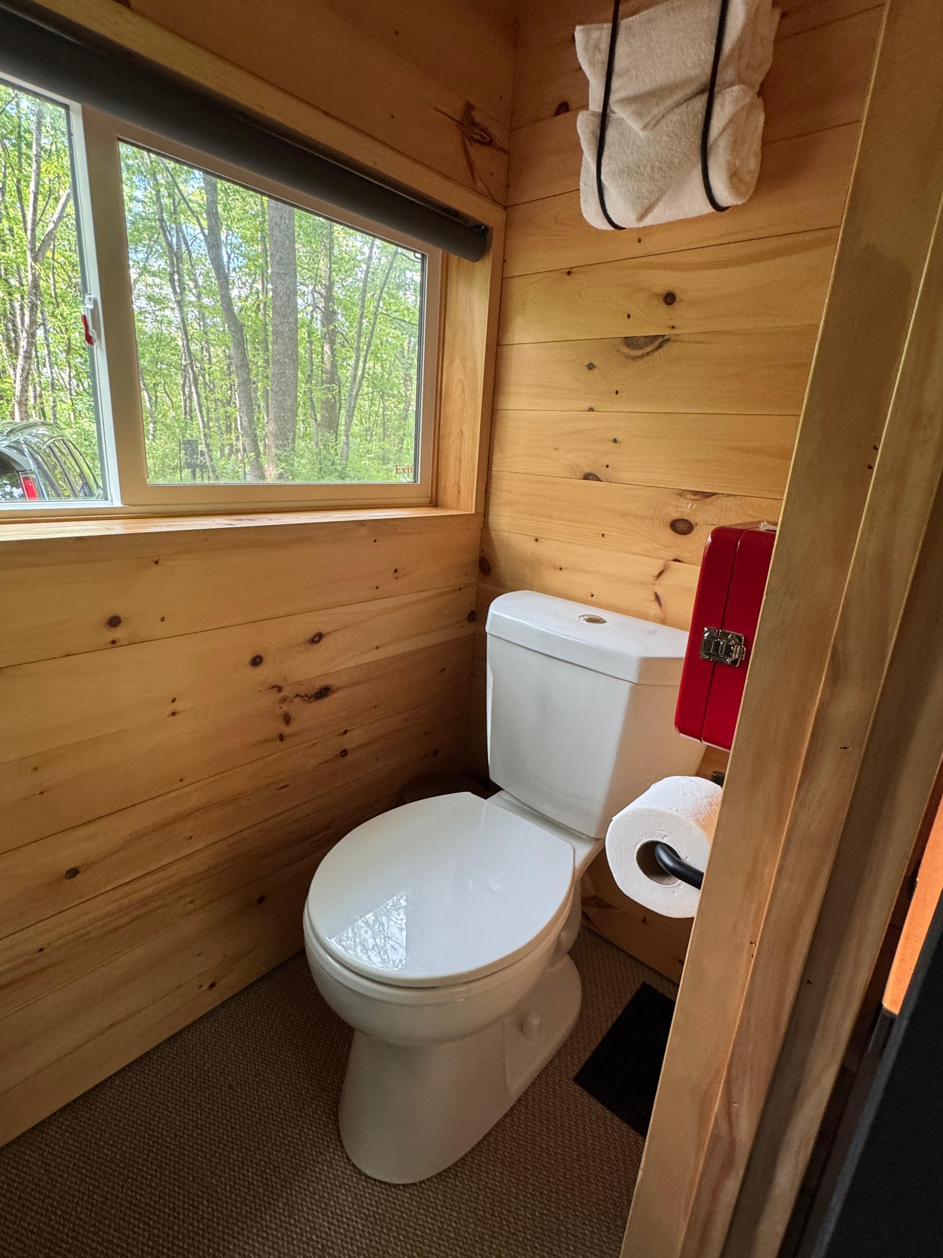 Shower stall not pictured, but faces toilet.