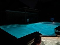 The pool at night while relaxing in the hot tub
