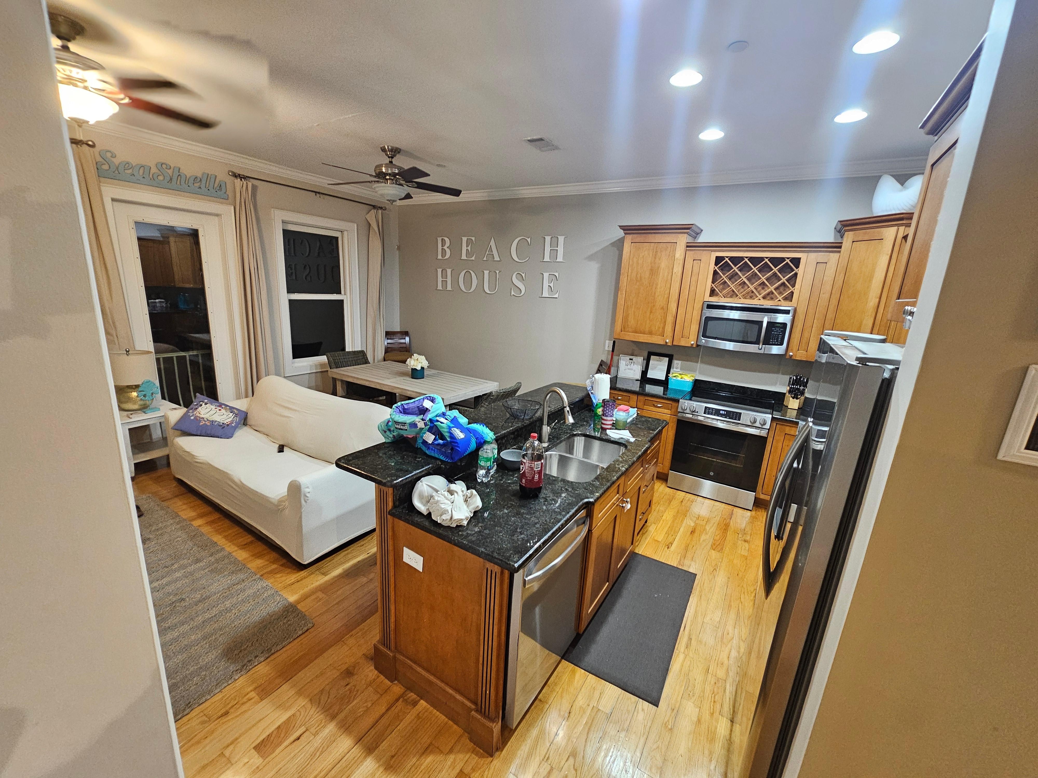 the kitchen and living area from the top of the stairs on the 2nd floor. 
