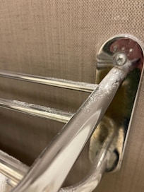 Drywall/plaster dust will on towel rack.