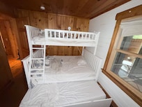 Kids' bedroom sleeps 4: one on top, two on the lower bunk and one in the pull-out trundle bed