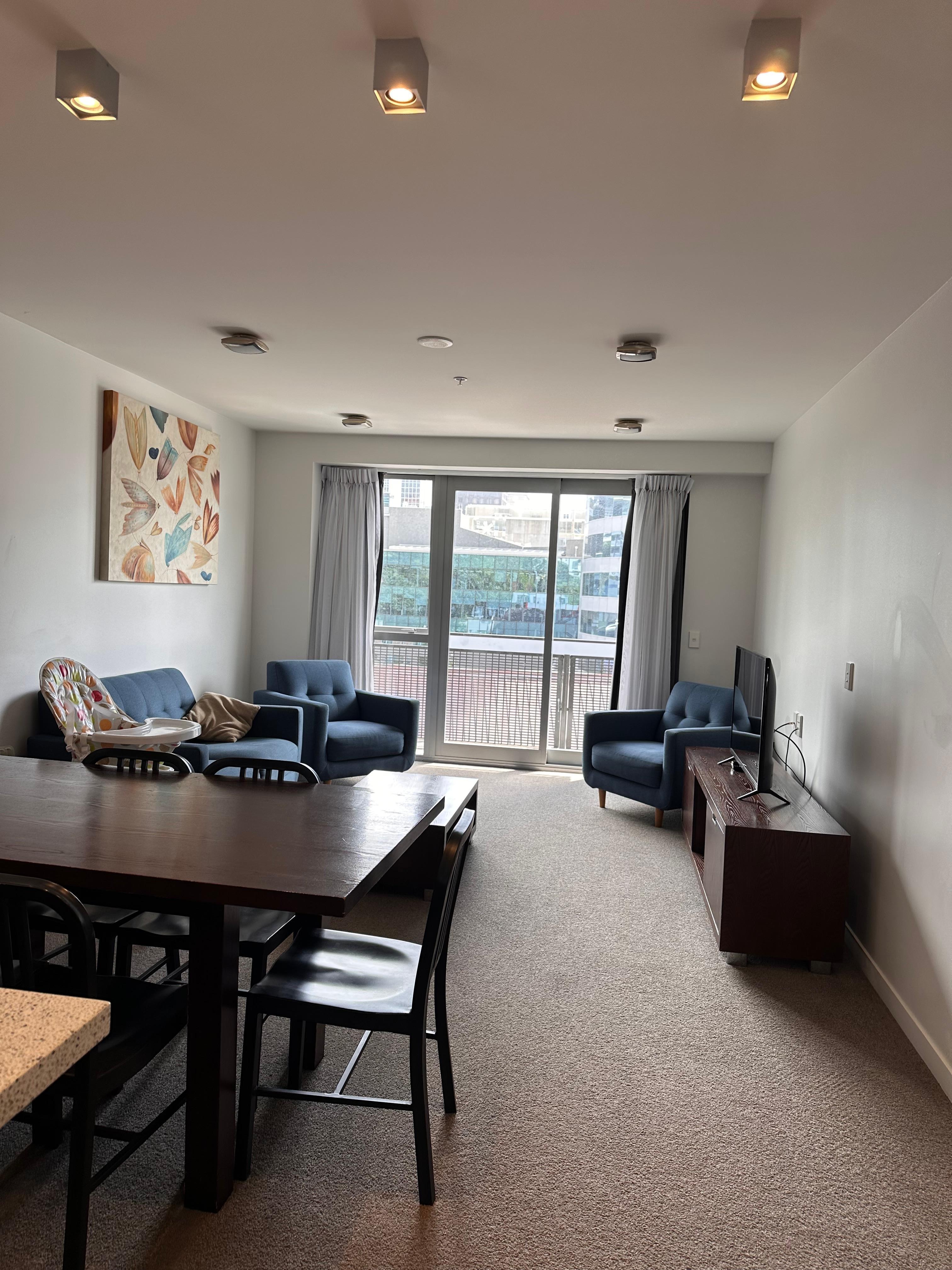 The lounge and dining area in a two-bedroom apartment.