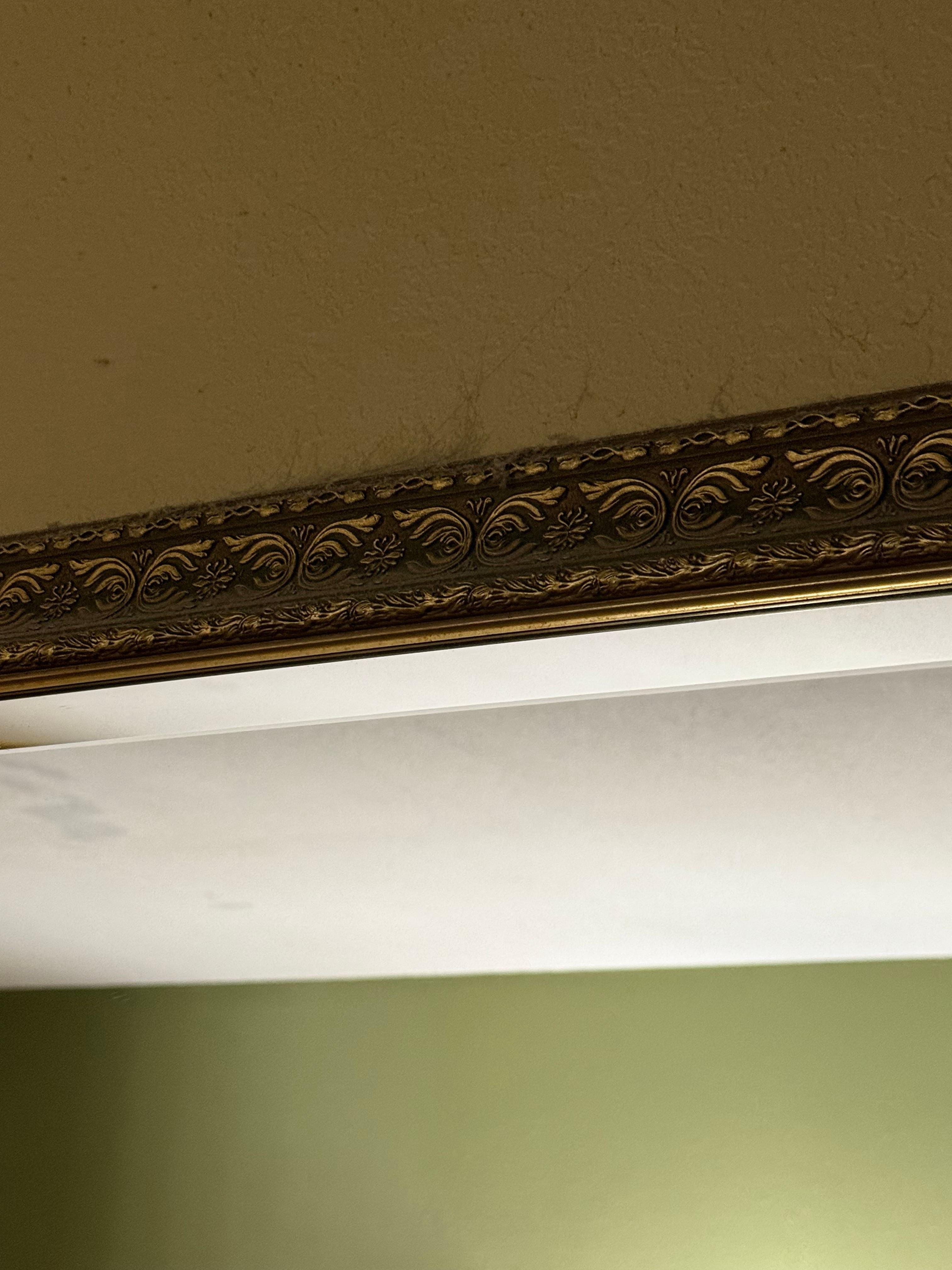 Cobwebs and dust above the mirror