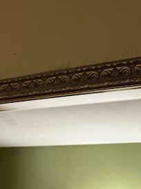 Cobwebs and dust above the mirror