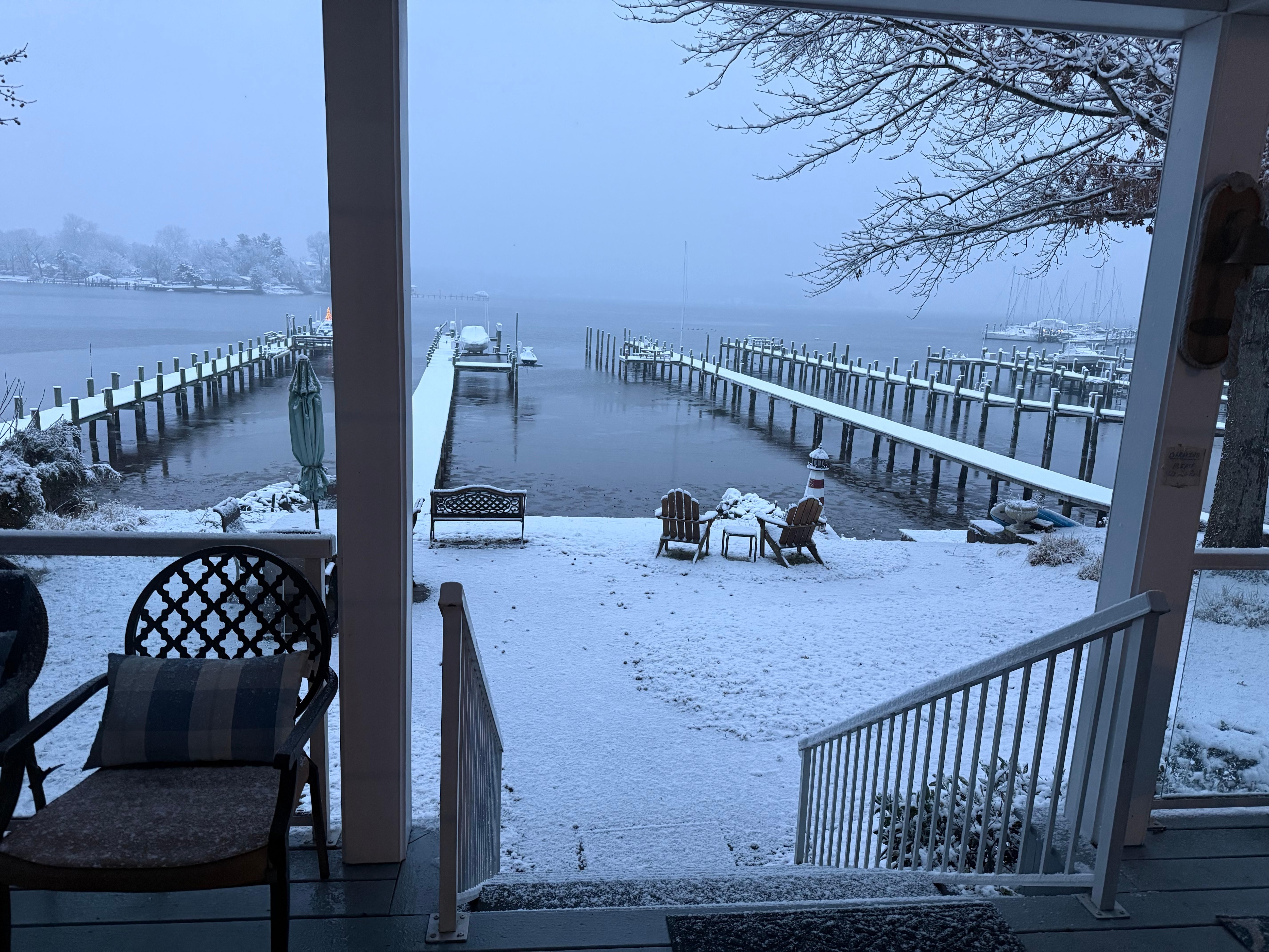 View of the water past the snow covered deck