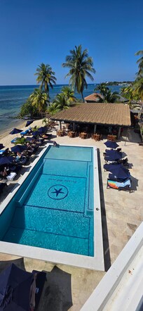 View from 3rd floor room balcony overlooking pool, bar, restaurant, beach and ocean