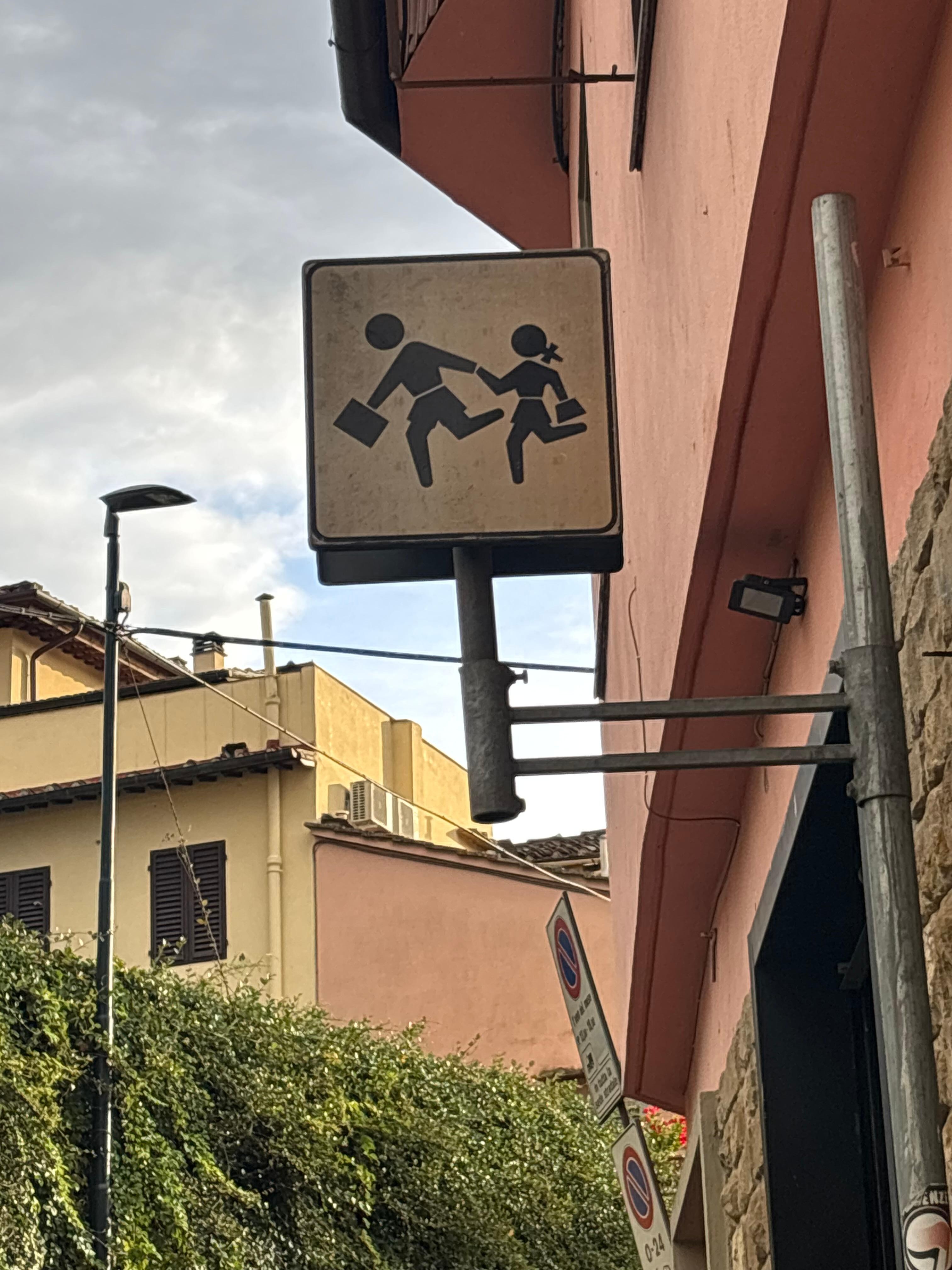 The warning sign to drivers that some people may be running to catch the bus.