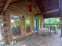 Front of the cabin with deck looking towards the roads (you can't see them in full foliage)