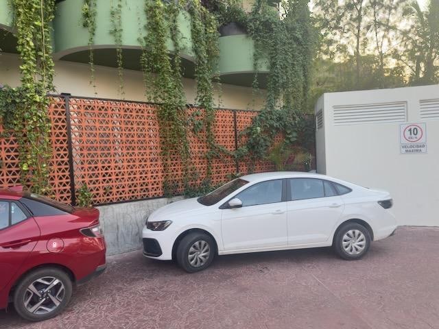 Room 9 is behind that white car