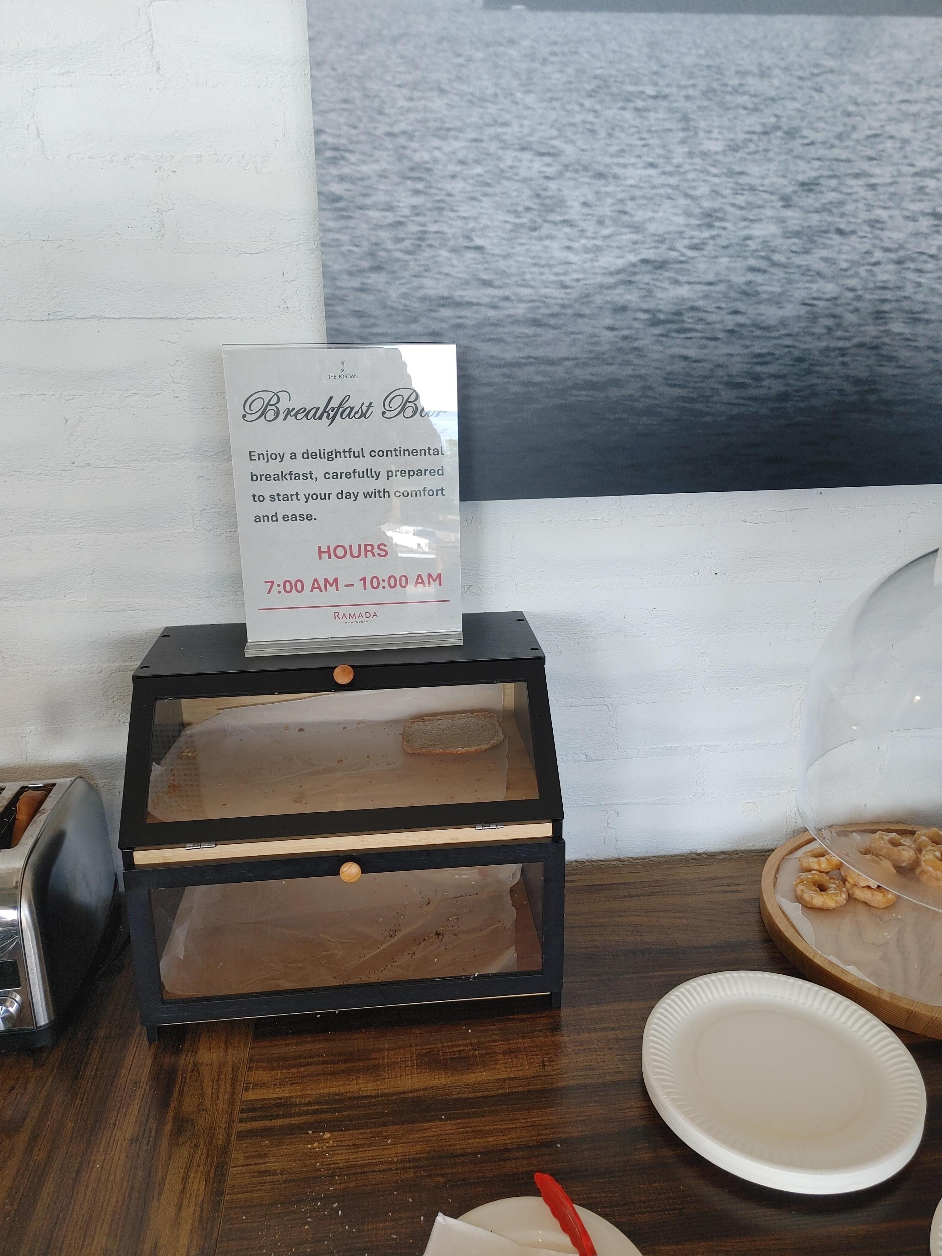Note the sign: "Enjoy a delightful continental breakfast carefully prepared to start your day with comfort and ease."
Also note the empty container.