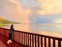 Sunset with rainbow from the patio above the beach