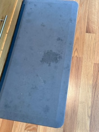 The rug by the kitchen sink. The one by the oven looked the same.