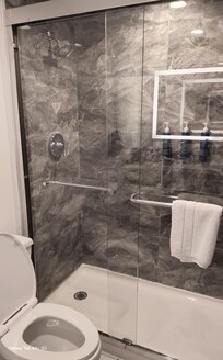 Marble backsplash & flooring, backlit wall mirrors, stylish decor