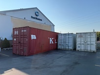 Railway containers in parking lot.