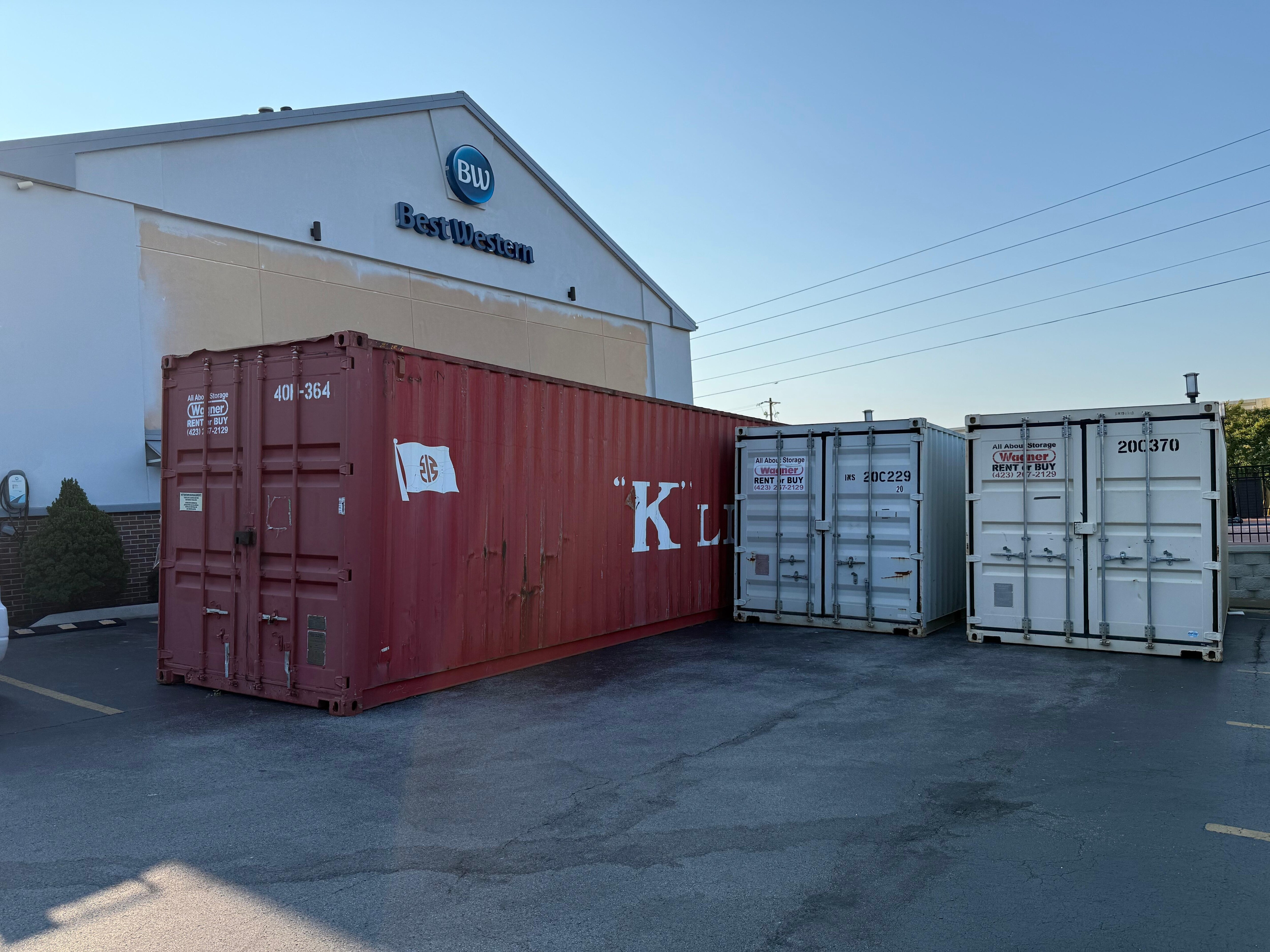 Railway containers in parking lot. 