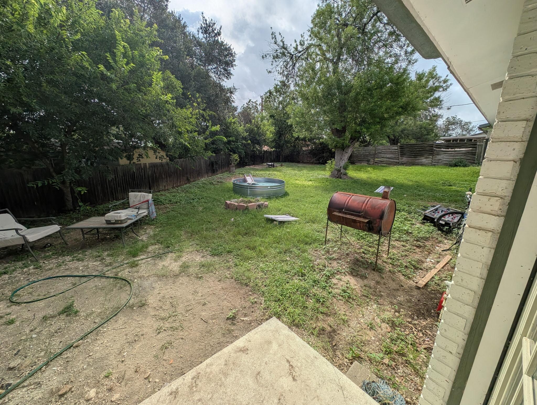 Trashed yard, fence down.